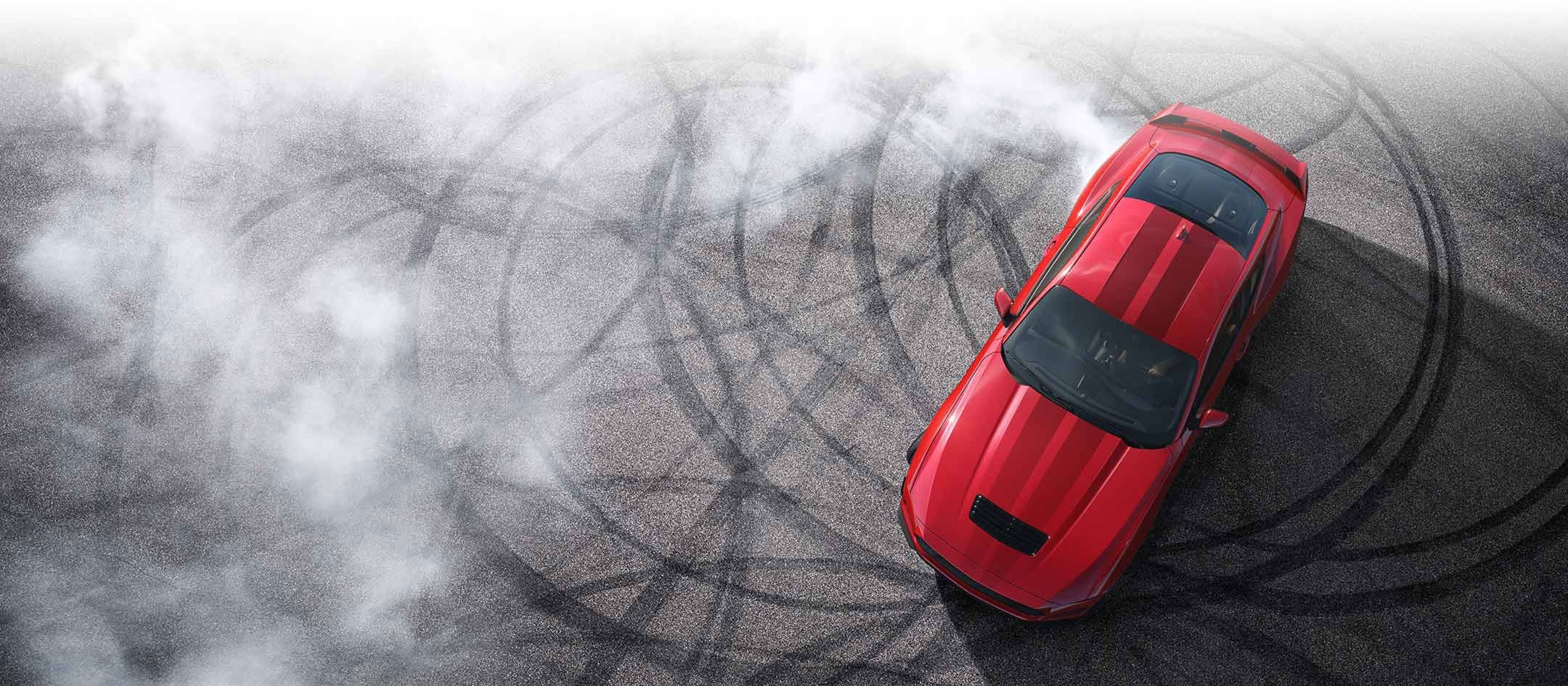 Overhead view of a 2024 Ford Mustang® model with tire tracks on pavement | Warrensburg Ford in Warrensburg MO